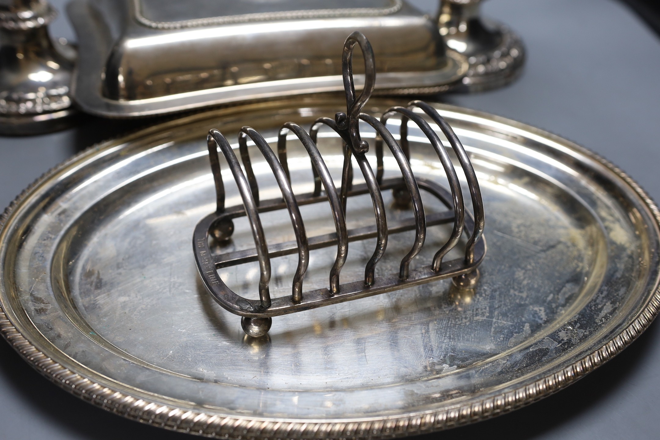 Plated wares to include a pair of telescopic candlesticks, toast rack and entree dishes